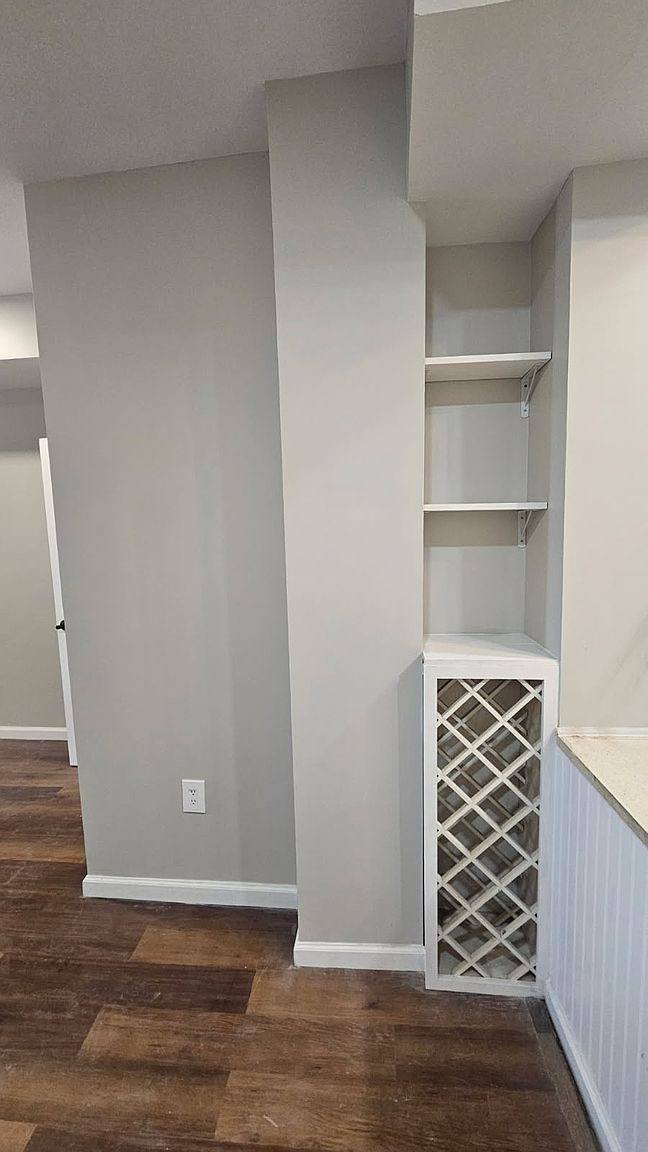 Built-in wine rack and open shelves next to the kitchen